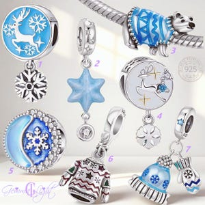 May include: A collection of seven silver charms featuring winter themes, including a blue reindeer disc, a star pendant, a polar bear, a moon and snowflake bead, a patterned sweater, and a hat and mitten set, all marked with 925 sterling silver.