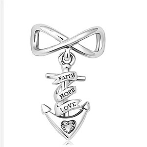 May include: A silver-toned metal charm featuring an infinity symbol at the top, connected to an anchor below. The anchor is wrapped in a ribbon with the engraved words FAITH, HOPE, and LOVE, and includes a small heart-shaped crystal at the base.