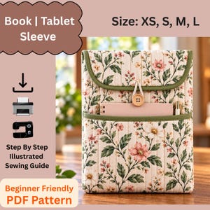 May include: A quilted fabric book or tablet sleeve featuring a floral pattern with pink flowers and green leaves on a cream background. The sleeve has a flap closure with a single wooden button, a front pocket, and green trim. Text includes Book | Tablet Sleeve, Size: XS, S, M, L, and Step By Step Illustrated Sewing Guide.