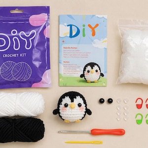 May include: A DIY crochet kit with a penguin theme. The kit includes purple packaging with "DIY CROCHET KIT" text, white and black yarn, a crochet hook, and a finished penguin. Also included are safety eyes, stitch markers, and stuffing.