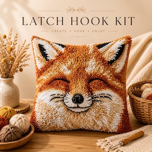 May include: A square latch hook kit pillow featuring a fox face with orange, white, and black yarn textures. The text LATCH HOOK KIT, CREATE, HOOK, ENJOY is visible above the pillow. The design includes a smiling fox with pointed ears.