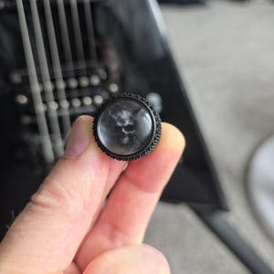 May include: A distressed white wooden sign displaying the word "Welcome" in a handwritten font. The sign has a rustic appearance with a floral design. The background is a blurred wooden texture.