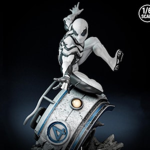 May include: A white and black Spider-Man action figure in a dynamic pose, perched atop a futuristic, weathered base with a blue and white design. The figure is 1/6 scale, with intricate detailing on the suit and base.