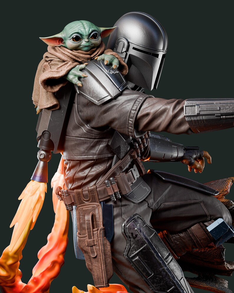 May include: A detailed figurine of The Mandalorian with Grogu. The Mandalorian is in dark armor with a helmet, and Grogu is perched on his shoulder, wrapped in a brown cloak. A flame effect emanates from the jetpack.