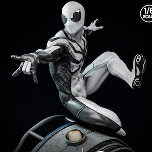 May include: A detailed, dynamic action figure of a superhero in a white and black suit, posed mid-leap. The figure is 1/6 scale, with intricate detailing on the costume and a textured appearance. The figure is set against a dark background.