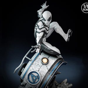 May include: A white and black Spider-Man action figure in a dynamic pose, perched atop a futuristic, weathered base with a blue and white design. The figure is 1/6 scale, with intricate detailing on the suit and base.