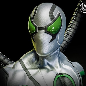 May include: A silver and black superhero costume with green accents. The costume features a textured pattern, green lenses, and a mechanical arm. The image includes a "1/6 SCALE" logo.