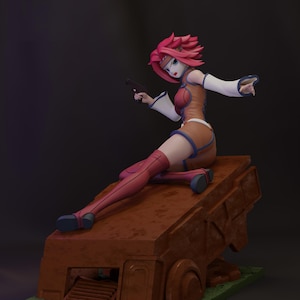 May include: A detailed figurine of a female anime character with pink hair, wearing a brown and red outfit, and holding a black pistol. The figure is seated on a brown, textured platform with a green base, set against a dark background.
