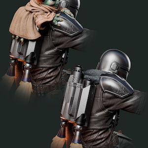May include: A detailed figurine of The Mandalorian with Grogu. The Mandalorian is wearing a dark gray helmet and armor, with a jetpack on his back. Grogu, wrapped in a brown cloak, is perched on his shoulder. The image has a dark green background.