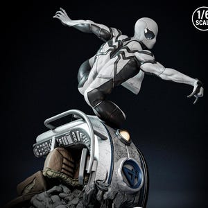 May include: A 1/6 scale statue of a superhero in a white and black suit, posed dynamically atop a futuristic vehicle. The figure is detailed with textured panels and a mask. The vehicle has a metallic finish and a blue emblem.