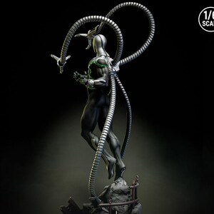 May include: A detailed 1/6 scale action figure of a character in a black and silver suit with four mechanical arms. The figure has green accents and is posed against a dark background. The figure is standing on a rocky base.