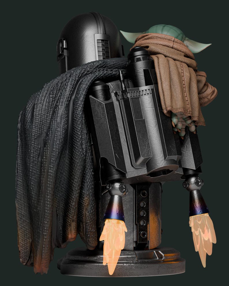 May include: A detailed statue of The Mandalorian with Grogu. The Mandalorian is clad in black armor with a cape, jetpack, and ignited thrusters. Grogu is wrapped in a brown blanket, perched on the Mandalorian's shoulder. The statue has a dark green background.