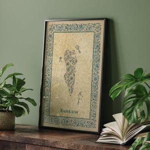 May include: A framed vertical wall art print featuring a map of Bahrain filled with intricate floral patterns. The map is set against a beige parchment-style background, enclosed by a decorative blue border with the word BAHRAIN printed below.