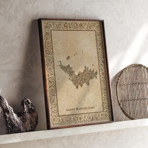 May include: A rectangular framed print featuring a vintage-style map of Saint Barthelemy centered on a beige parchment background. The frame is dark brown wood with an ornate, intricate floral border pattern surrounding the map illustration.