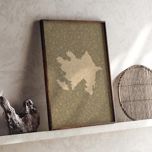 May include: A rectangular framed wall art piece featuring a beige silhouette map of Azerbaijan centred on a dark olive green background with a subtle, repeating floral pattern. The frame is a dark brown wood, providing a contrast to the print.