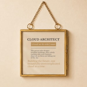 May include: A square wall hanging with a thin gold metal frame and a matching gold chain. The print features the text CLOUD ARCHITECT, a phonetic pronunciation, the noun classification, and a definition about designing invisible buildings.