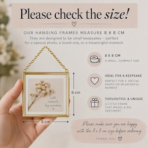May include: A square hanging frame with a gold metal border and a gold chain. The frame contains a white insert with a dried white flower and the text 'Little moments big memories'. The frame measures 8 x 8 cm as indicated by text.