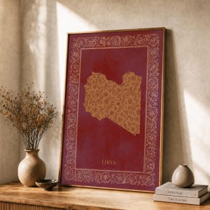 May include: A framed vertical wall art print featuring a map of Libya in a golden floral pattern set against a deep red background. The print is enclosed by an ornate, intricate golden floral border and includes the text LIBYA at the bottom.