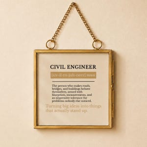 May include: A square wall hanging in a thin gold metal frame with a chain for suspension. The print features the text CIVIL ENGINEER, a phonetic pronunciation, and a definition describing the profession, ending with the phrase Turning big ideas into things that actually stand up.