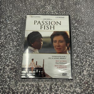 May include: DVD of the film "Passion Fish" featuring Mary McDonnell and Alfre Woodard. The cover includes images of the actresses and the film's title. The DVD is nominated for two 1992 Academy Awards.