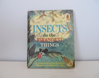 May include: A vintage children's book titled "INSECTS do the STRANGEST THINGS" with illustrations of insects and a ladybug on a leaf. The book cover is blue, green, and white.