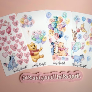 May include: Four rectangular sticker sheets featuring watercolor illustrations of Winnie the Pooh characters, balloons, and hearts with dollar amounts. Each sheet includes the text Beauty and the Budgett. A pink sign with the text @BeautyandtheBudgett.