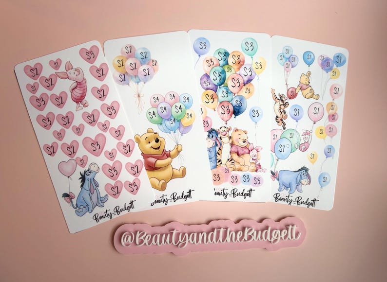 May include: Four rectangular sticker sheets featuring watercolor illustrations of Winnie the Pooh characters, balloons, and hearts with dollar amounts. Each sheet includes the text Beauty and the Budgett. A pink sign with the text @BeautyandtheBudgett.