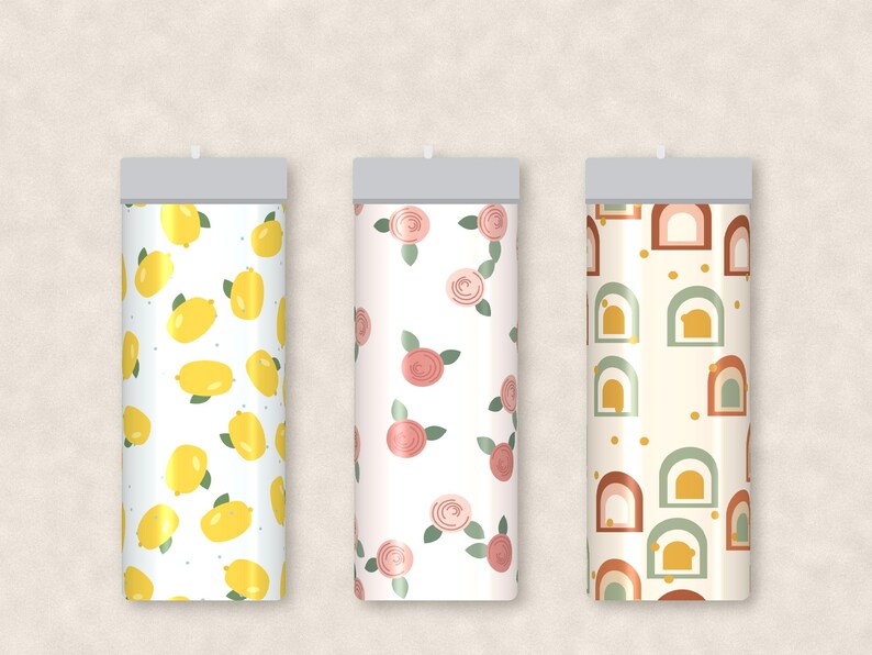 May include: Three cylindrical tumblers with distinct patterns. The first features yellow lemons and green leaves on white. The second displays pink roses with green leaves on white. The third shows a repeating pattern of arches in terracotta, sage green, and yellow.