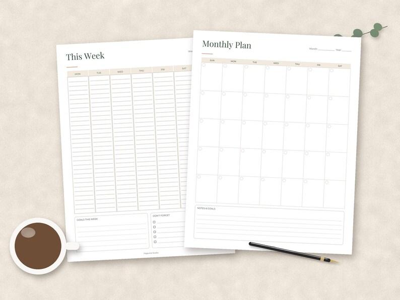 May include: Two white paper planner sheets featuring a weekly schedule titled This Week and a monthly calendar titled Monthly Plan. The weekly sheet includes columns for days and sections for goals and tasks. The monthly sheet has a grid layout.