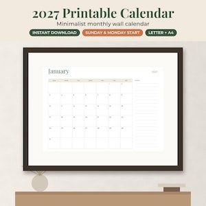 May include: A 2027 printable monthly wall calendar displayed in a dark brown frame. The calendar page shows the month of January with a grid layout, a notes section on the right, and the text 2027. The design features a neutral color palette.