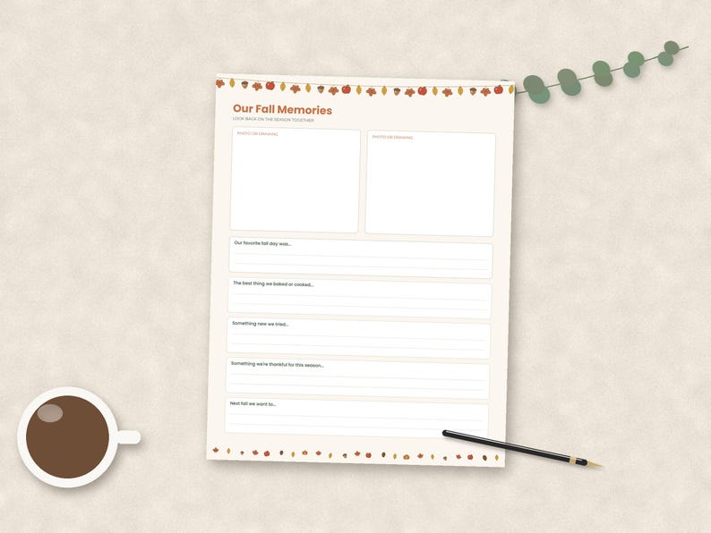 May include: A cream-colored paper sheet titled Our Fall Memories with a decorative border of autumn leaves and acorns. The page includes two blank rectangular boxes for photos and several lined sections for writing prompts about seasonal activities.
