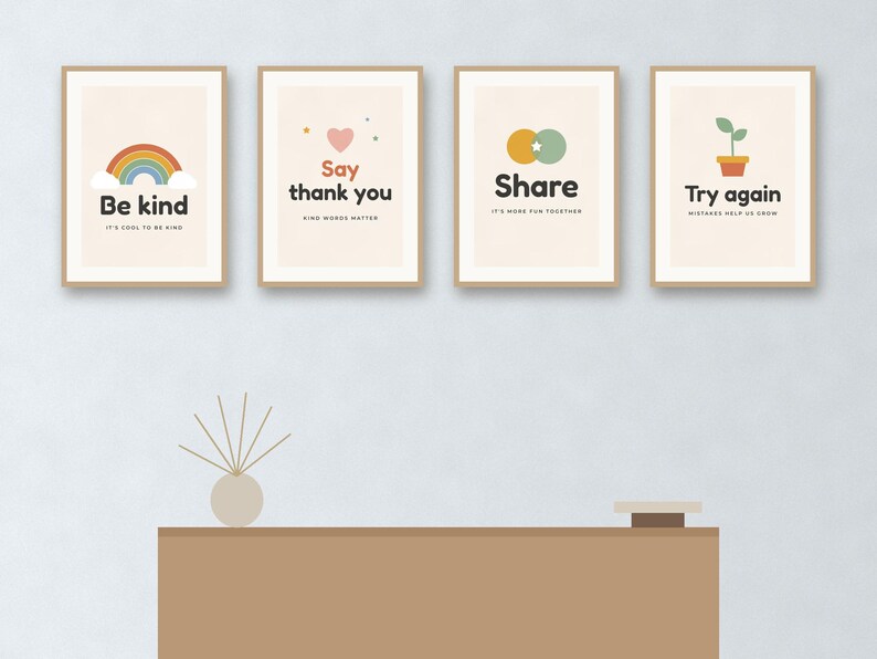 May include: Four rectangular wall art prints in light wood frames. The first features a rainbow and the text Be kind, IT'S COOL TO BE KIND. The second shows a heart and Say thank you, KIND WORDS MATTER. The third has overlapping circles and Share, IT'S MORE FUN TOGETHER. The fourth displays a potted plant and Try again, MISTAKES HELP US GROW.
