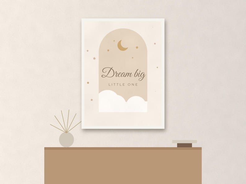 May include: A rectangular wall print featuring an arched window design in shades of beige and cream. The artwork displays a crescent moon, small stars, and white clouds with the text Dream big LITTLE ONE centered in dark brown script and print.