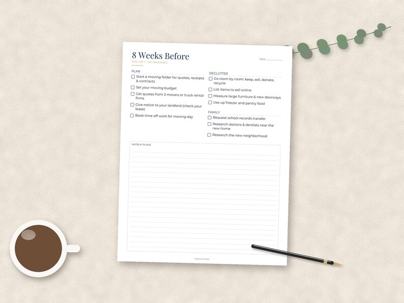 May include: A white paper checklist titled 8 Weeks Before with sections for planning, decluttering, and family tasks, featuring checkboxes and a lined notes area at the bottom. A black pen and a cup of coffee are placed next to the document.
