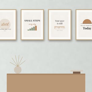 May include: Four framed wall art prints with light beige backgrounds and motivational text. The first reads start WHERE YOU ARE, the second SMALL STEPS every day with a bar graph, the third Your pace is still progress, and the fourth BUILD SOMETHING Today.