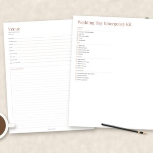 May include: Two white paper sheets featuring black text and lines. One sheet is titled Venue with contact fields and a notes section. The other sheet is titled Wedding Day Emergency Kit with a checklist of items. A coffee cup and pen are visible.