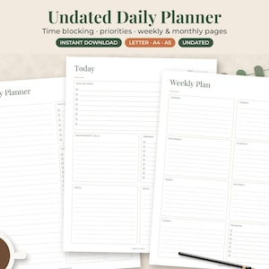 May include: Three white paper sheets featuring an Undated Daily Planner layout with black text. The pages include sections for Daily Planner, Today, and Weekly Plan with checkboxes, lines, and headers. A coffee cup and a black pen are visible.