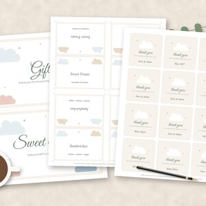 May include: Three sheets of printable paper featuring cloud-themed designs. One sheet displays gift and sweet treat signs, another lists food items like sandwiches, and the third contains twelve square thank you tags with cloud graphics.