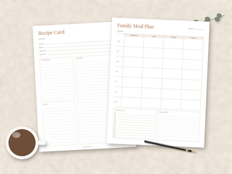 May include: Two white paper sheets featuring minimalist layouts. One sheet is titled Recipe Card with sections for ingredients, method, and notes. The other is titled Family Meal Plan with a weekly grid for breakfast, lunch, dinner, and snacks.
