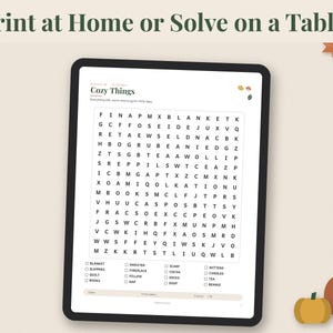 May include: A digital tablet displaying a word search puzzle titled Cozy Things with a grid of letters and a list of words to find below. The text Print at Home or Solve on a Tablet appears at the top, with autumn leaf and pumpkin graphics.