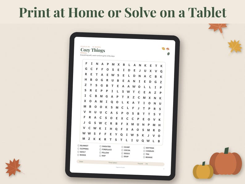 May include: A digital tablet displaying a word search puzzle titled Cozy Things with a grid of letters and a list of words to find below. The text Print at Home or Solve on a Tablet appears at the top, with autumn leaf and pumpkin graphics.