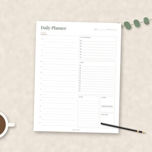 May include: A white daily planner sheet with black text and lines. The layout includes a schedule section, a top 3 priorities list, a to-do list, a notes section, a water intake tracker with eight circles, and a gratitude section at the bottom.