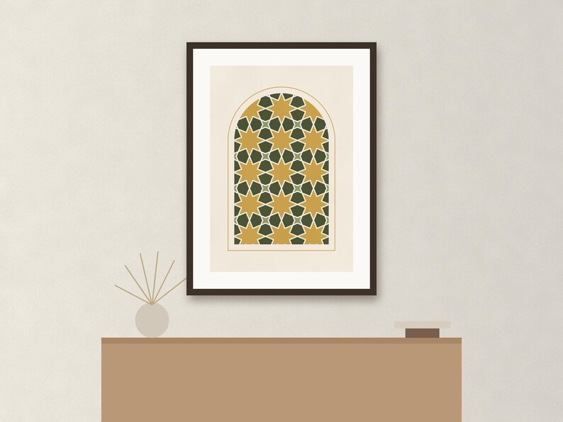 May include: A framed wall art print featuring an arched window design with a repeating geometric pattern of eight-pointed stars in mustard yellow and dark forest green, set against a light cream background within a dark brown frame.