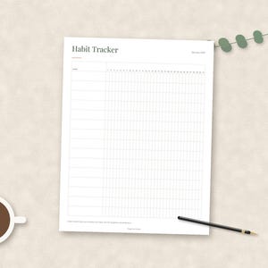 May include: A white paper habit tracker sheet with black text reading Habit Tracker and January 2021. The grid features rows for habits and columns numbered one through thirty-one. A black pen and a small green eucalyptus sprig are placed nearby.