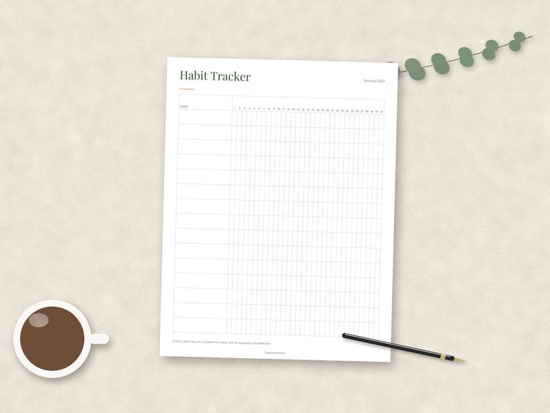 May include: A white paper habit tracker sheet with black text reading Habit Tracker and January 2021. The grid features rows for habits and columns numbered one through thirty-one. A black pen and a small green eucalyptus sprig are placed nearby.