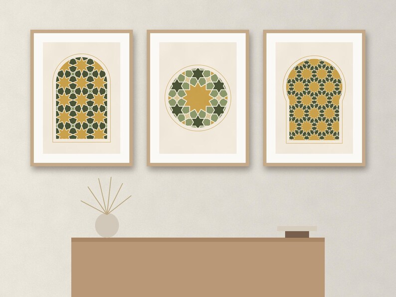May include: Three framed wall art prints featuring geometric star patterns in shades of mustard yellow, dark green, and cream. The two outer prints are set within arched window shapes, while the center print displays a circular star motif.