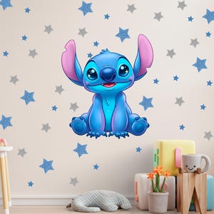 May include: A blue cartoon character with large eyes and ears, sitting on a wall decorated with blue and silver glitter stars. The character has a friendly expression and is surrounded by star-shaped wall decals, creating a playful nursery theme.