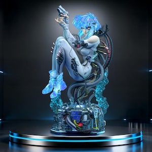 May include: A futuristic figurine of a woman with blue hair and a white bodysuit, holding a gun. The figure is seated on a complex mechanical base with tubes and wires, and is surrounded by glowing blue accents. The statue is displayed on a round platform.