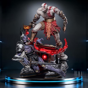 May include: A detailed statue of a muscular, pale-skinned warrior with red markings, standing over a defeated purple-skinned figure. The warrior wears red and brown attire and holds a weapon. The base features a glowing red element.