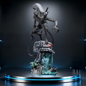 May include: A detailed, dark gray Alien Xenomorph statue, poised atop a futuristic, cylindrical base with a cracked glass container. The base is on a round, metallic platform with blue neon lighting, set against a dark background.